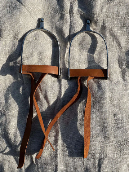 Stainless steel riding spurs with brown leather straps